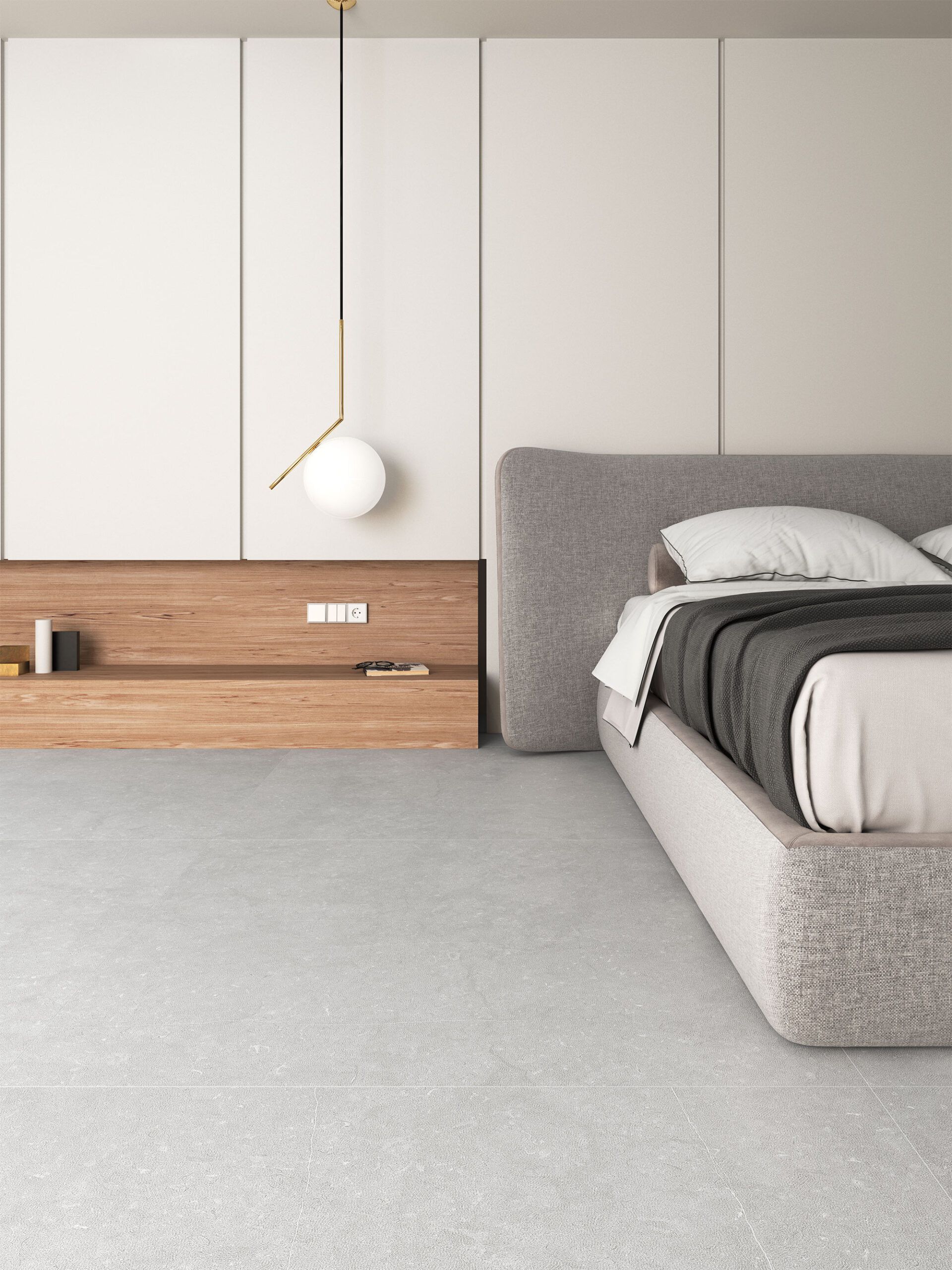 Dormitorio minimalista con cama gris, paredes blancas, mesita de noche de madera y lámpara colgante de globo.