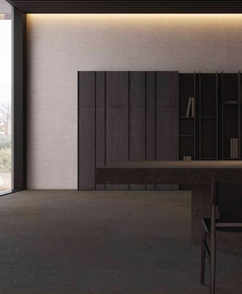 Interior moderno minimalista con armarios oscuros, estanterías empotradas e iluminación cálida empotrada.