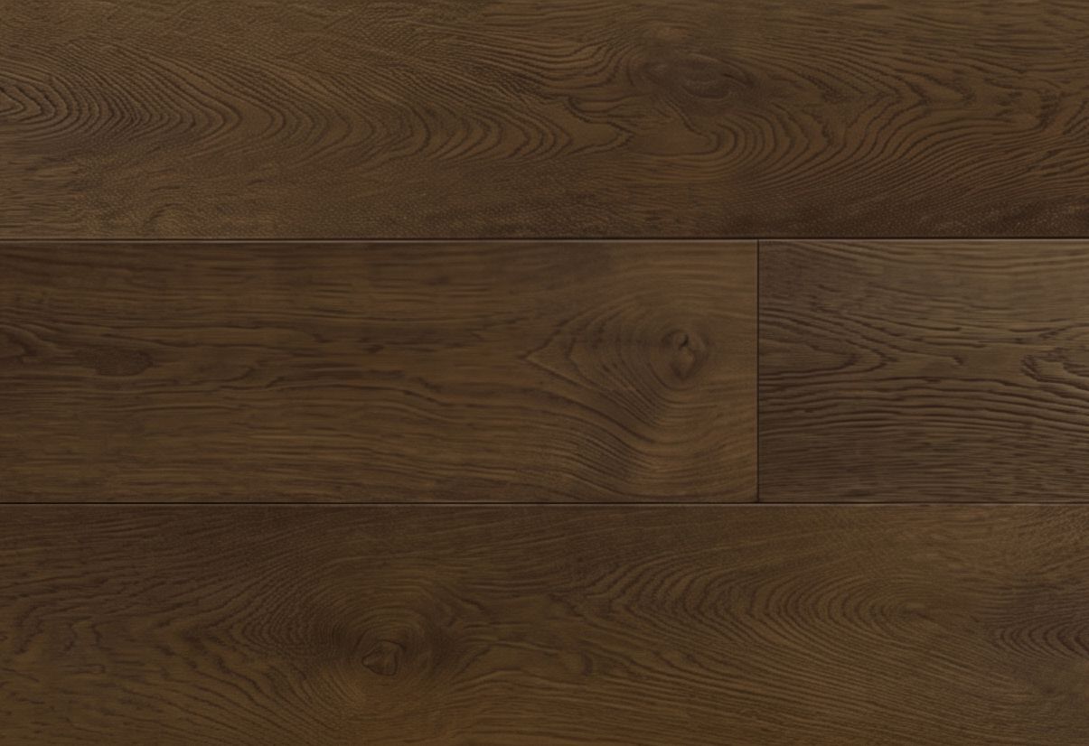 Suelo de madera en espiga en tonos marrones cálidos, mostrado en primer plano.