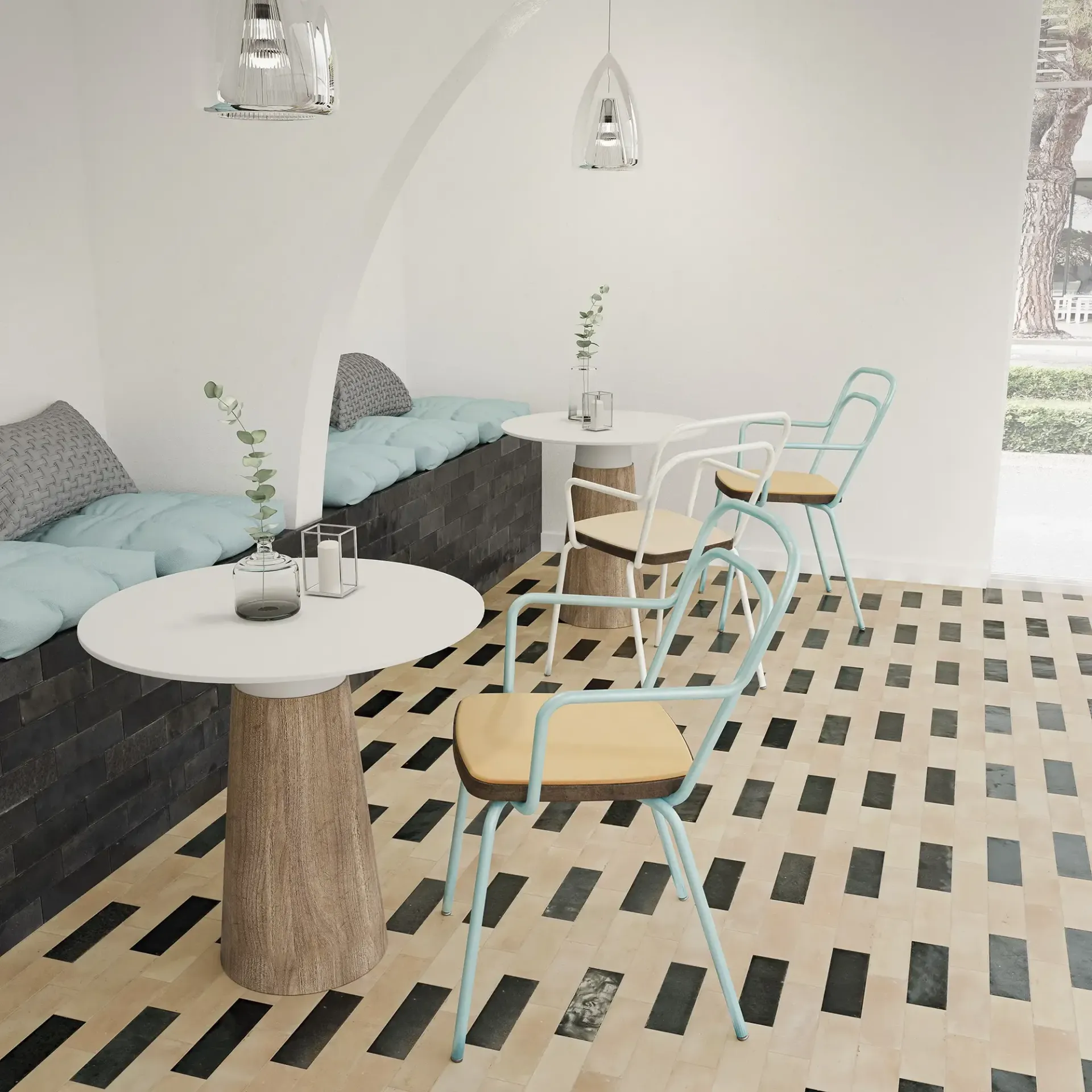Interior minimalista de una cafetería con sillas color menta, una mesa redonda blanca y suelo de baldosas blancas y negras.