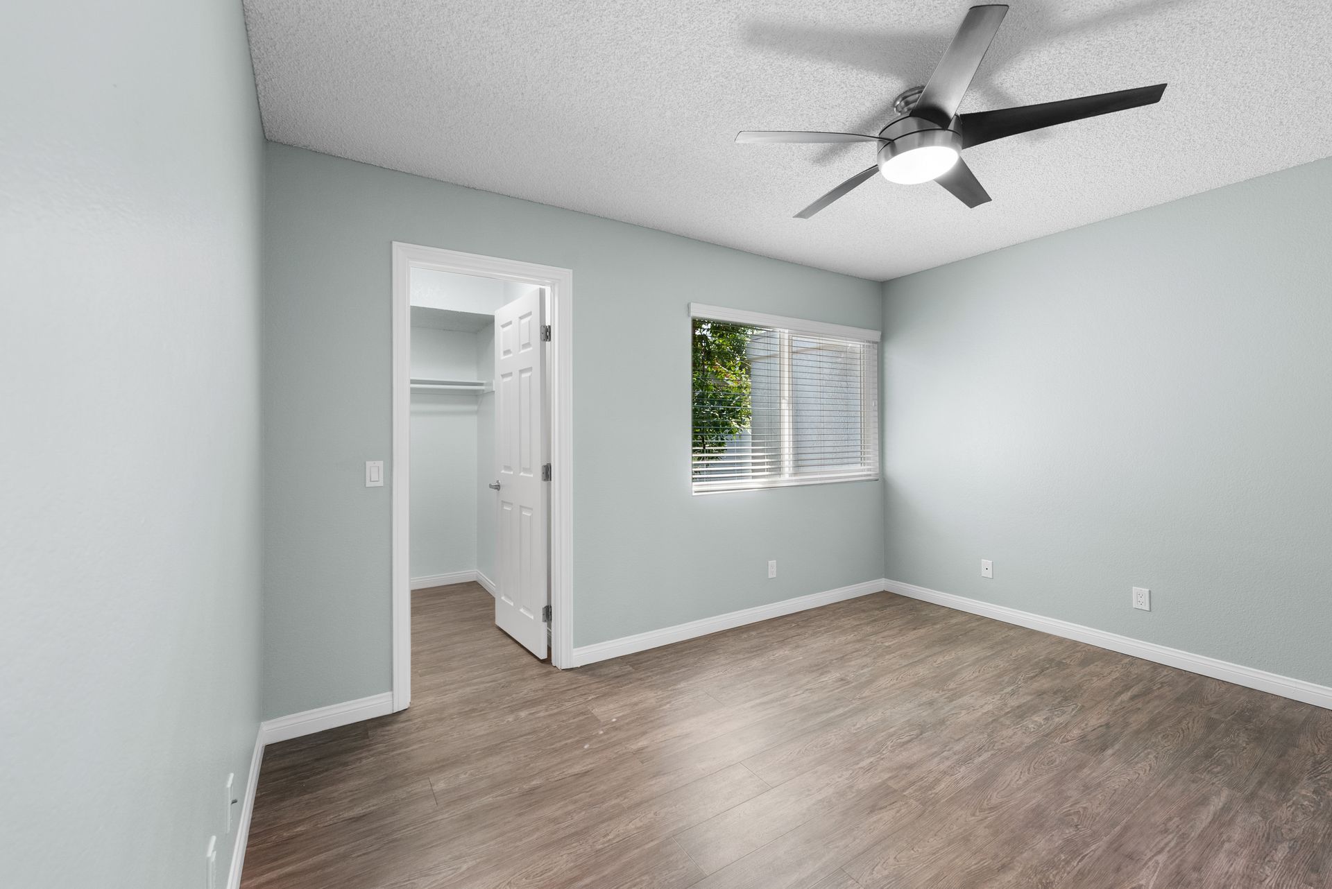 Bedroom with ceiling fan and window