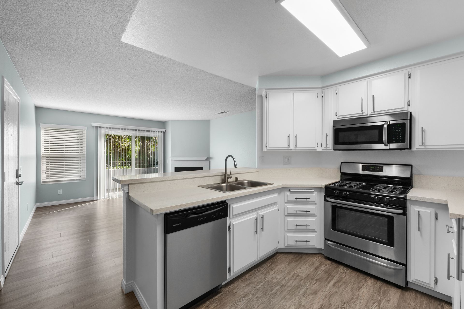 Kitchen with dishwasher, sink, and stove