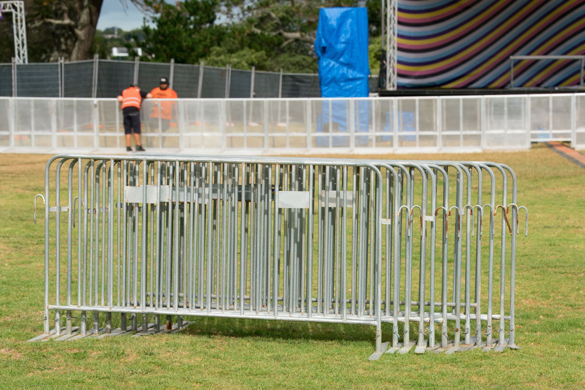 Event barriers on lawn in front of stage under construction. Event barriers on lawn in front of stage under construction.