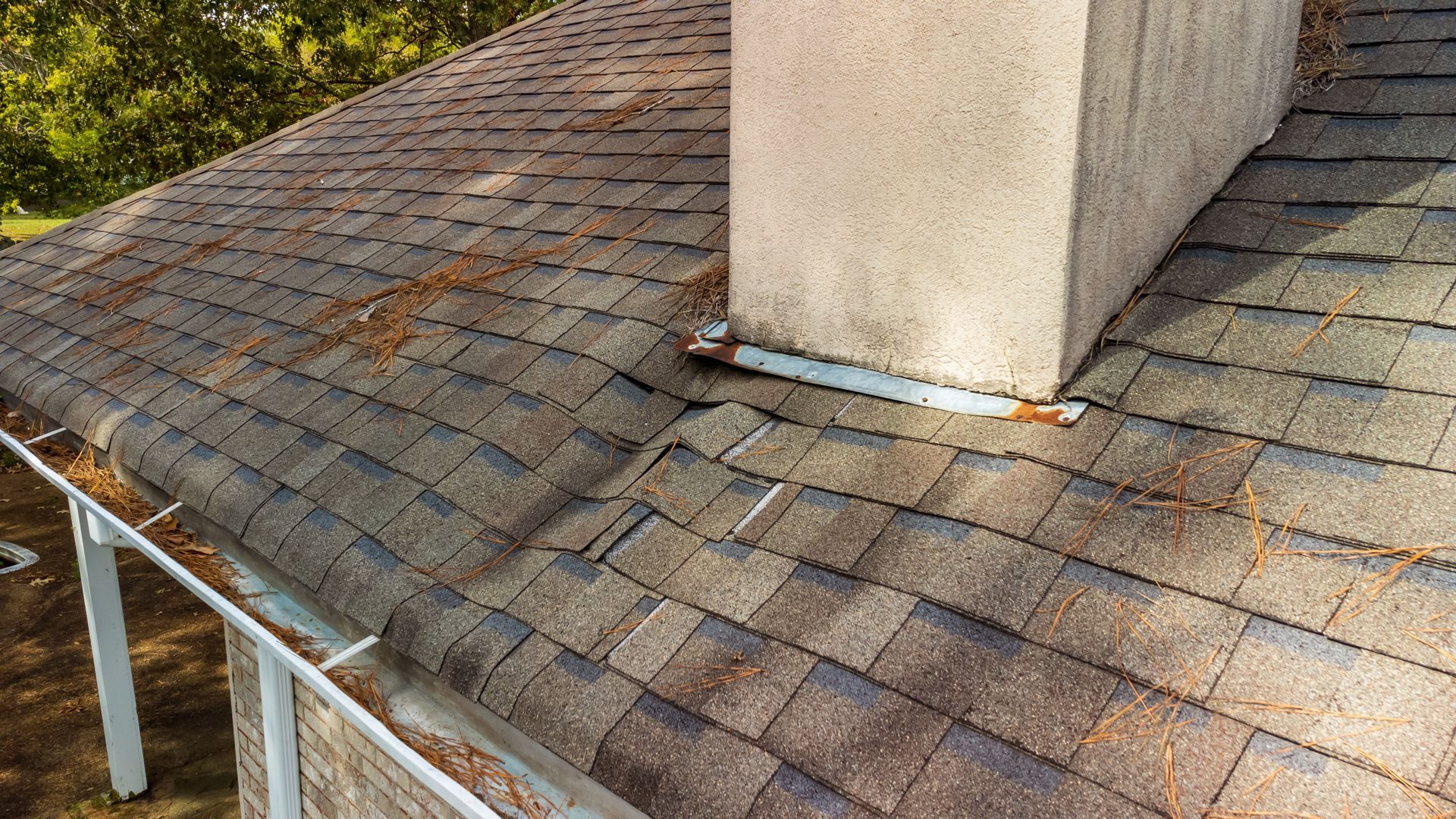 There is a chimney on the roof of a house.