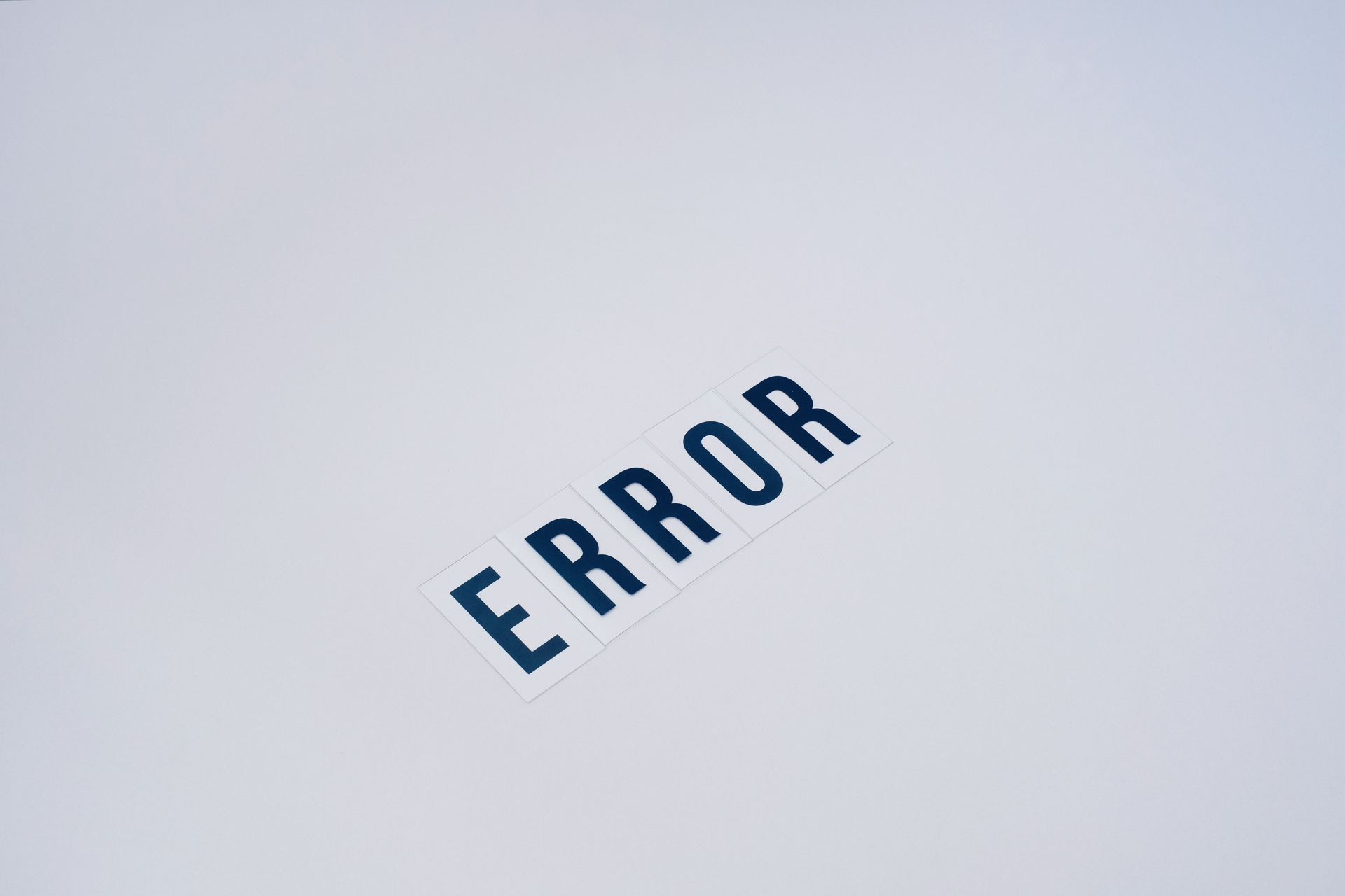 Blue “ERROR” text tilted on a light gray background.