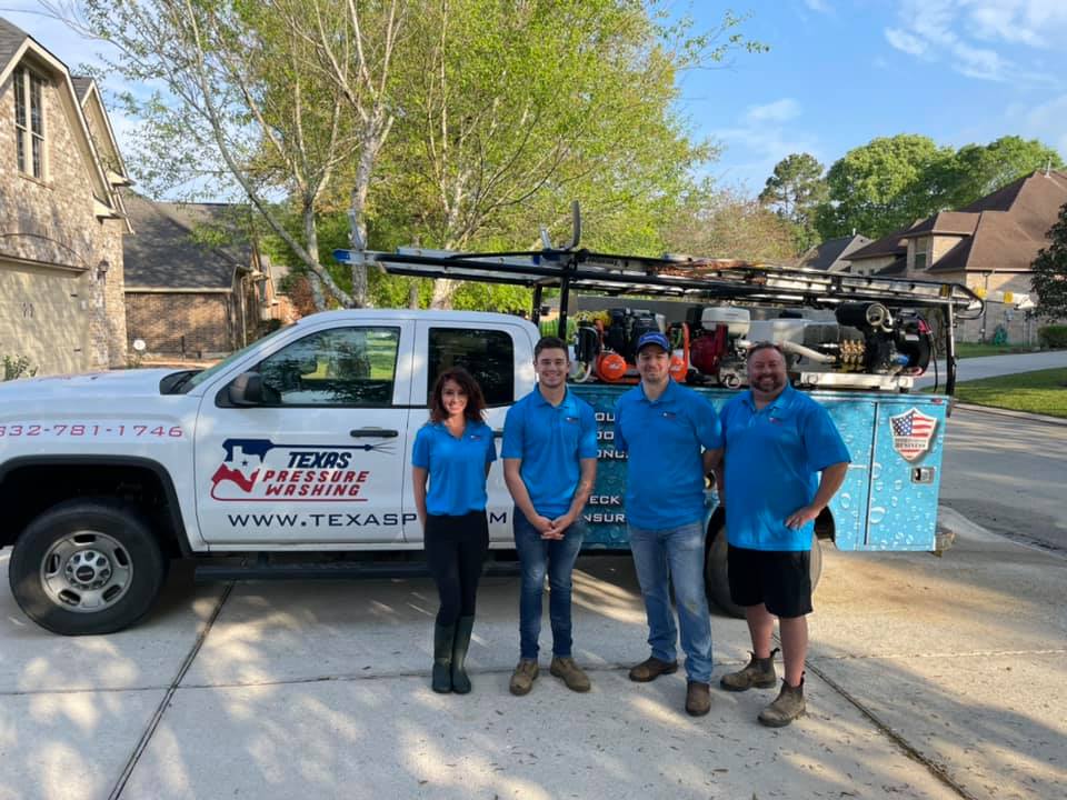 A group of people standing in front of a truck.