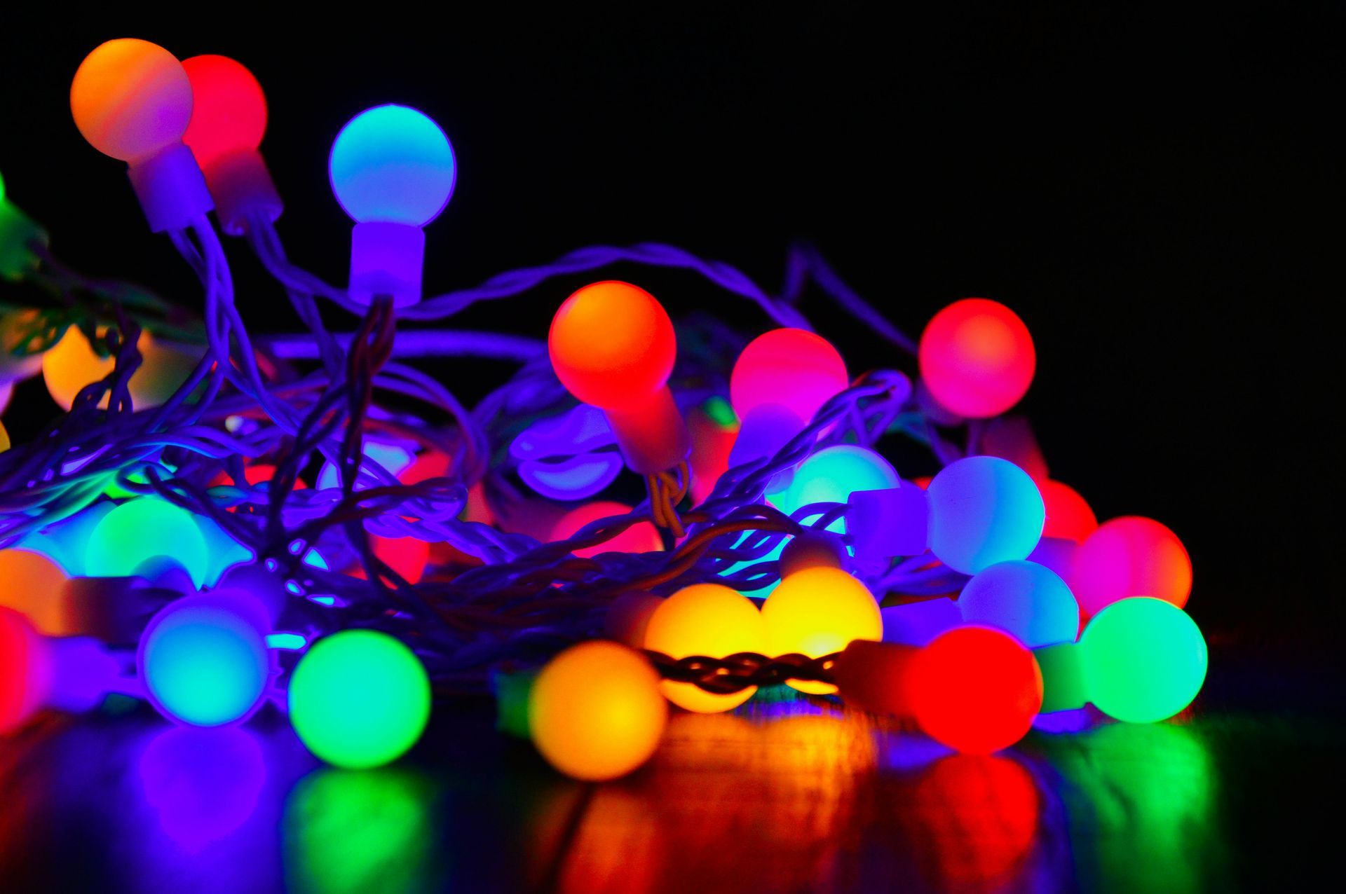 A bunch of colorful christmas lights are sitting on a table.