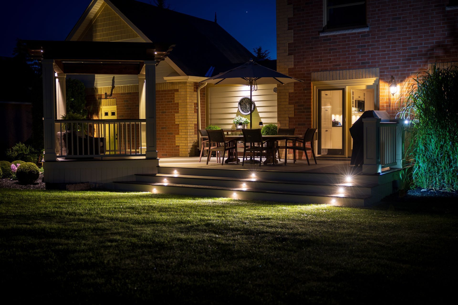 The backyard of a house is lit up at night