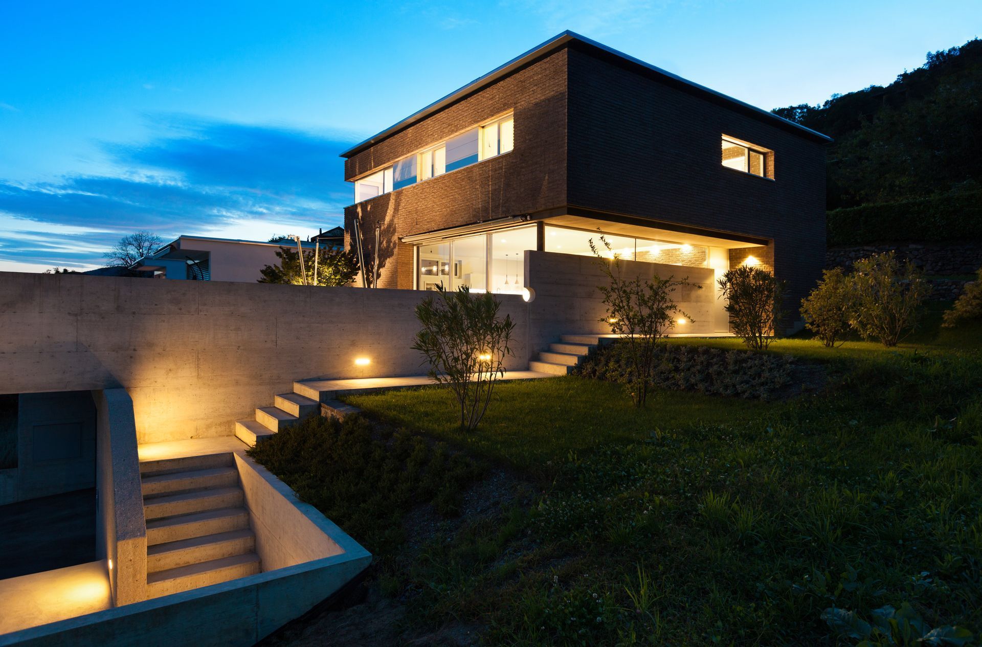 A house with stairs leading up to it is lit up at night