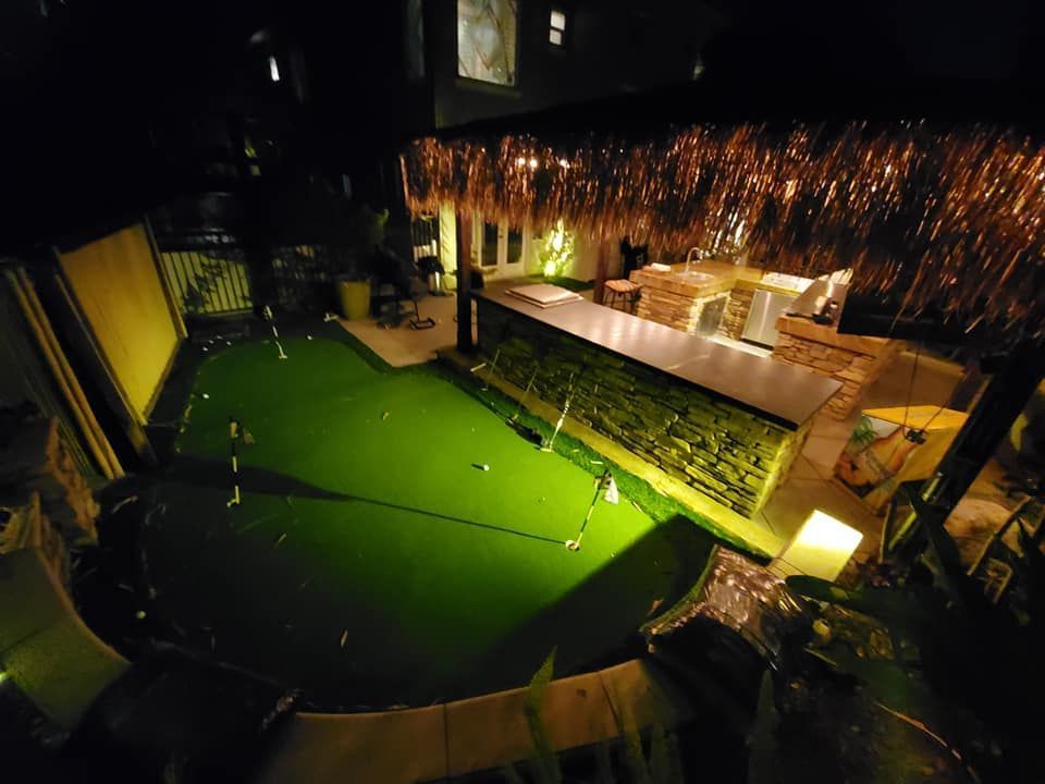There is a green lawn in the middle of the room.