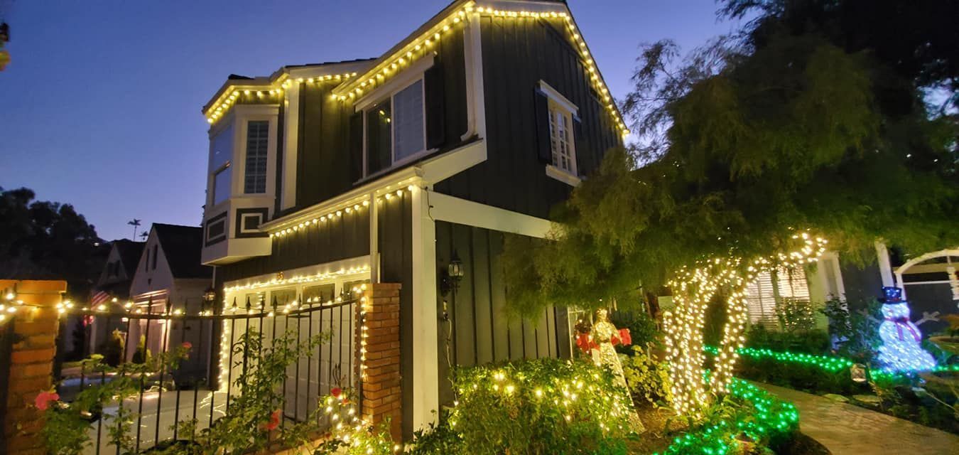 A house is decorated with christmas lights at night.