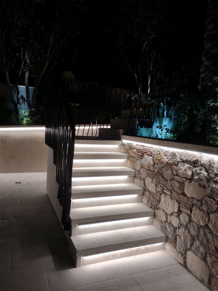 A set of stairs that are lit up at night.