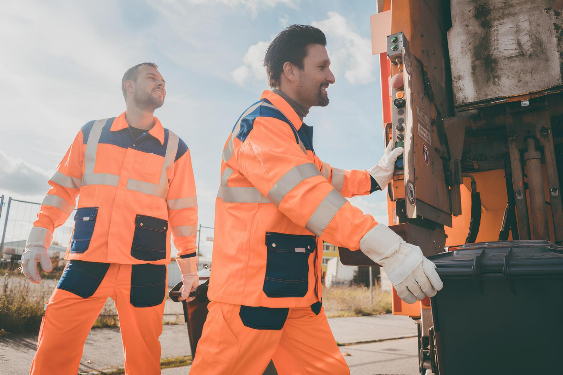 Two Garbage Collectors Are Walking Towards a Garbage Truck — IBS Skip Bins in Warana, QLD