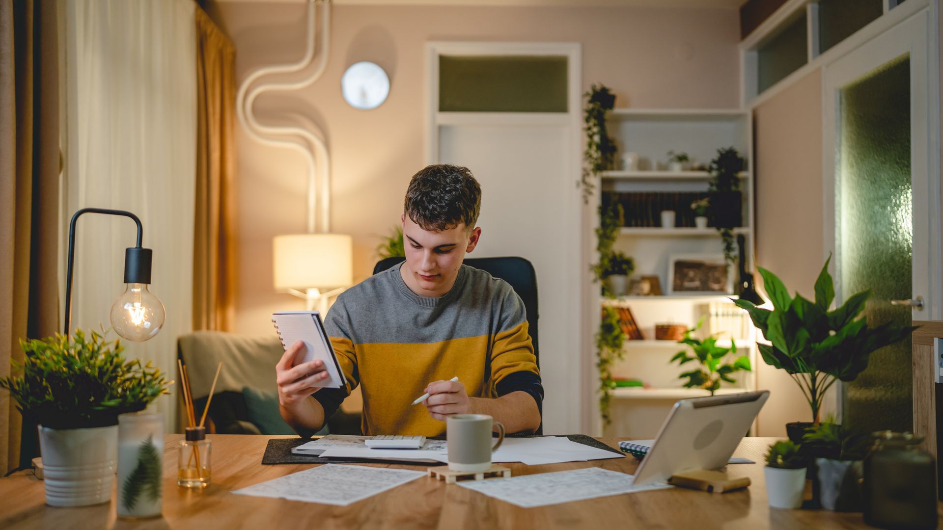 a student studying in their home at night