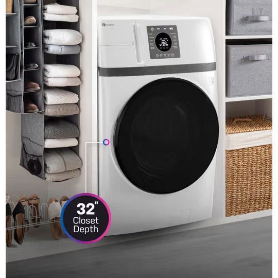 White washer dryer in a closet with a 32-inch depth. Clothes and shoe storage are visible.