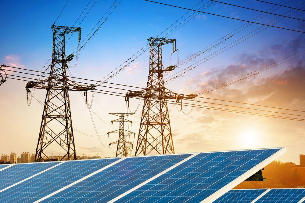 There are solar panels and power lines in the background.