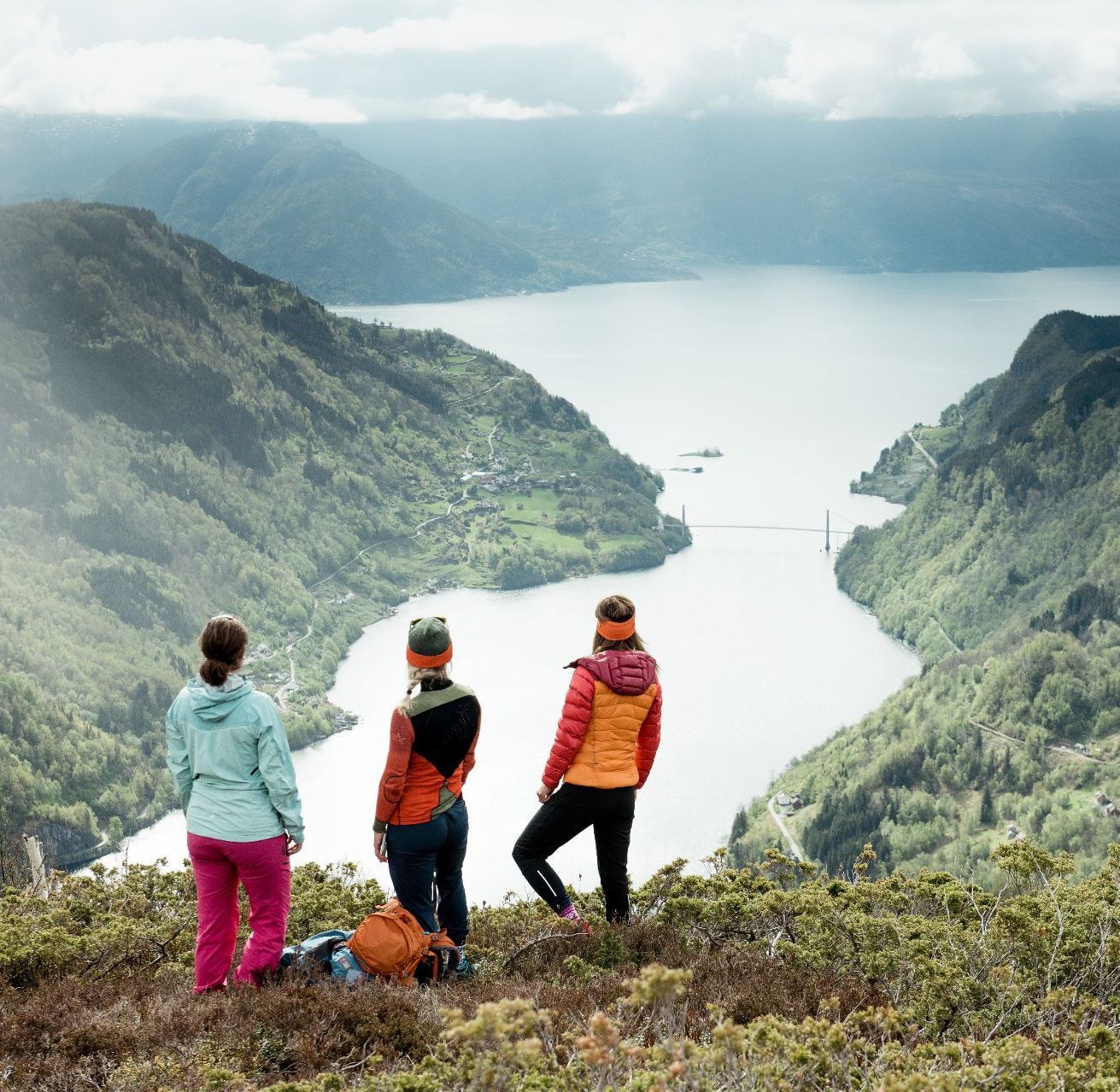 People on a guided hike in Øystese enjoying the view over outer parts of the Fyksesund fjord branch of the Hardangerfjord.