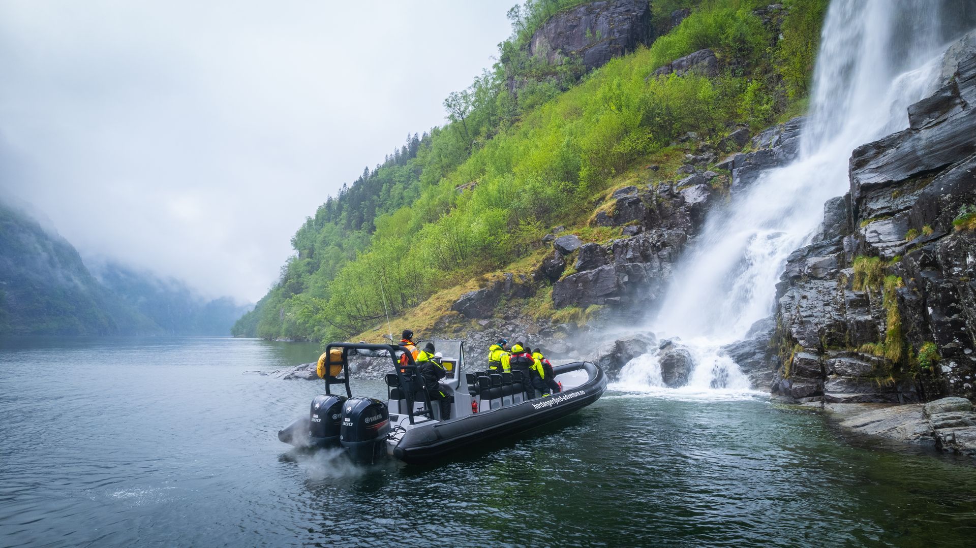 RIB boat close to waterfall in Fyksesund, Hardangerfjord