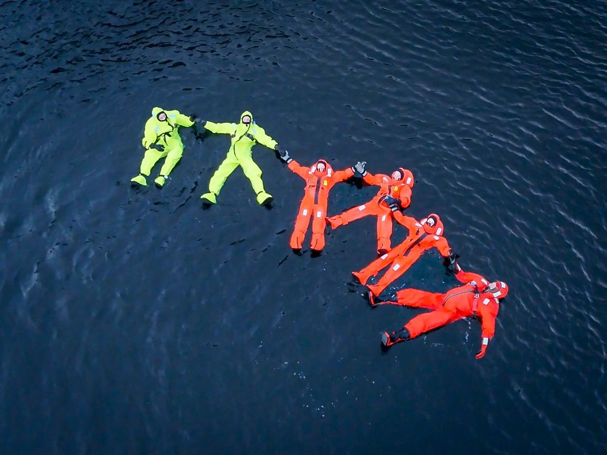 Air shot of people floating in the Hardangerfjord.