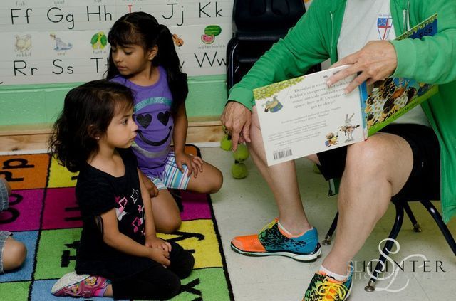 A Woman Is Reading a Book to Two Little Girls