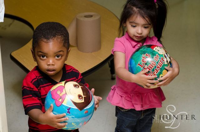 A Boy and A Girl Are Holding a Christmas Ball