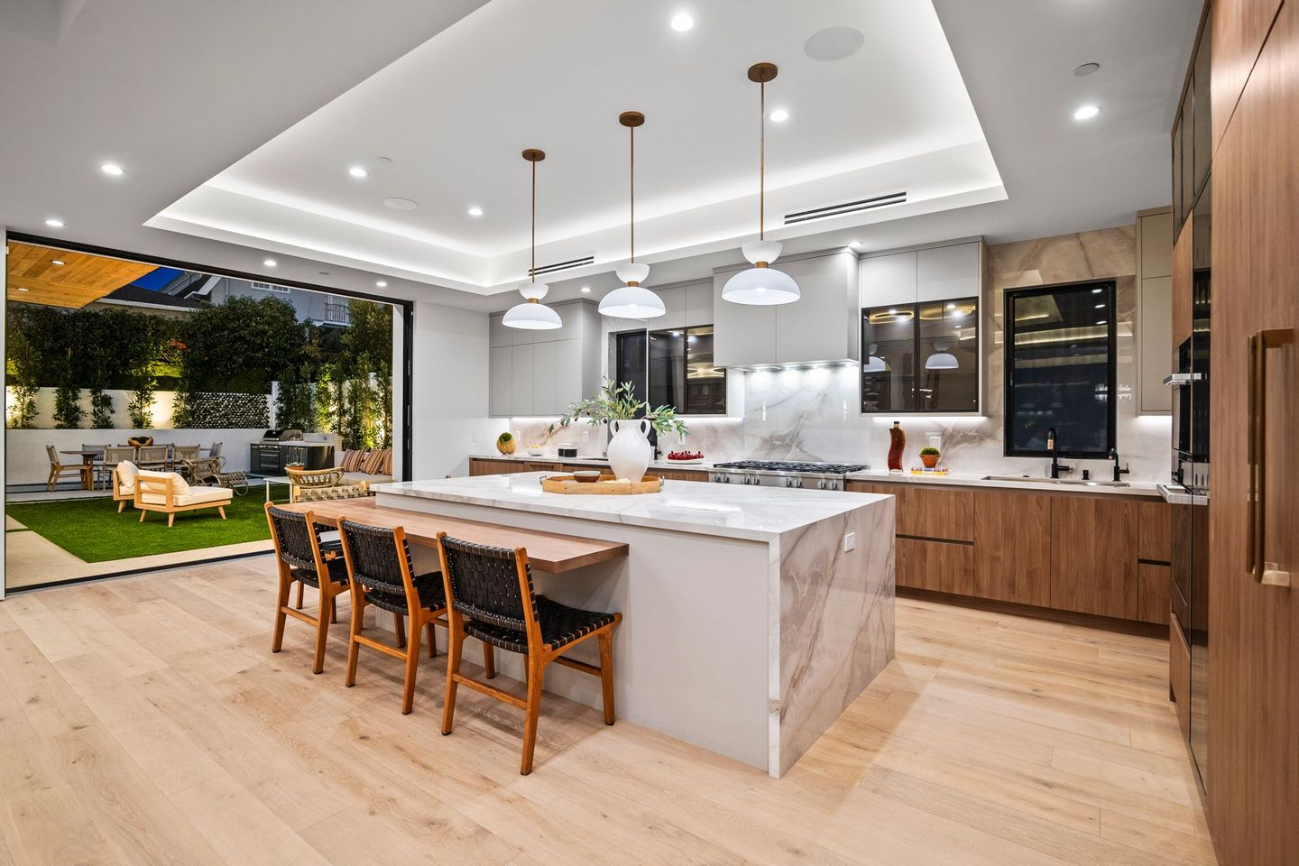 A kitchen with a large island and a dining table.