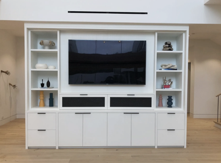 A kitchen with a long bar and stools