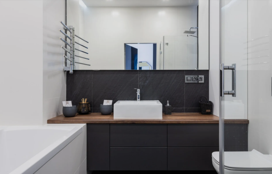 A bathroom with a sink , toilet , bathtub and mirror.