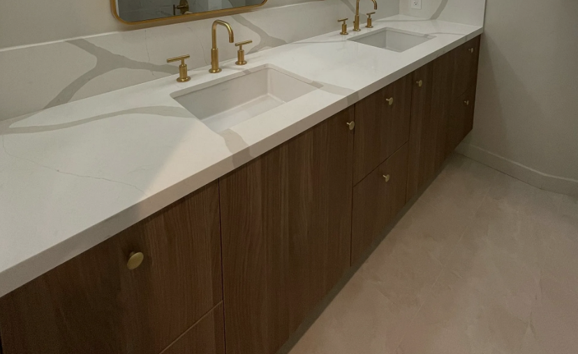 A kitchen with wooden cabinets and white counter tops