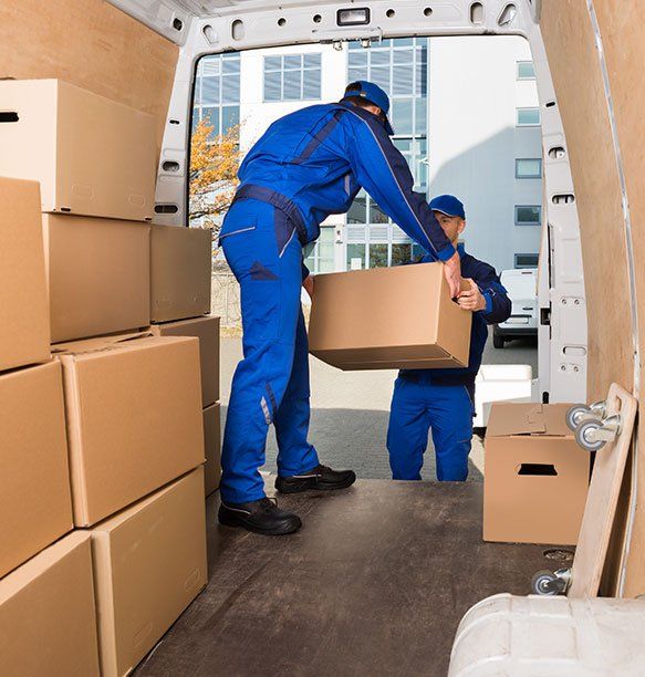 Men Putting Boxes On A Van — Newton, WI — Nomad Moving Services Men Putting Boxes On A Van — Newton, WI — Nomad Moving Services