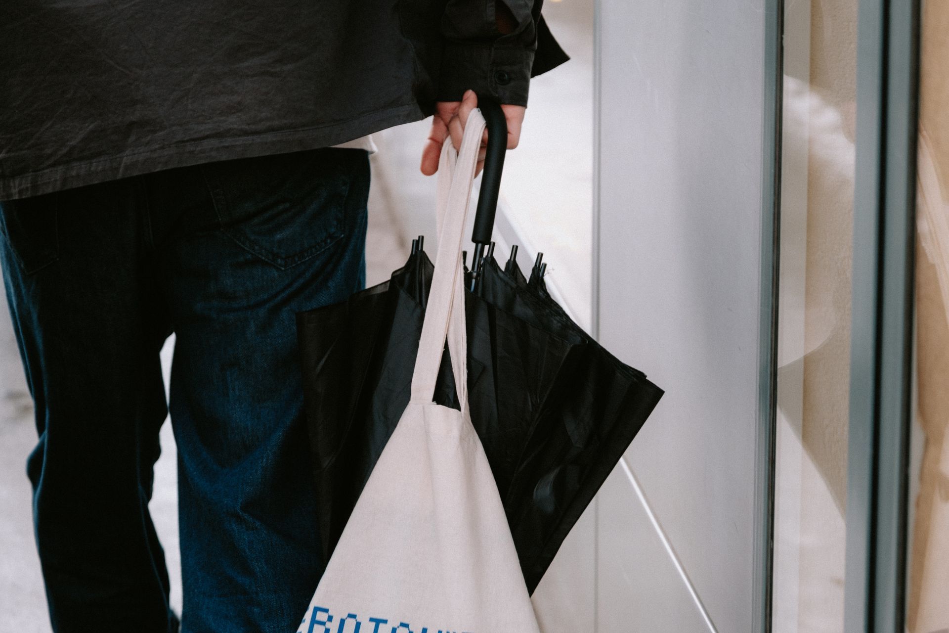 Man carrying a canvas tote bag outdoors