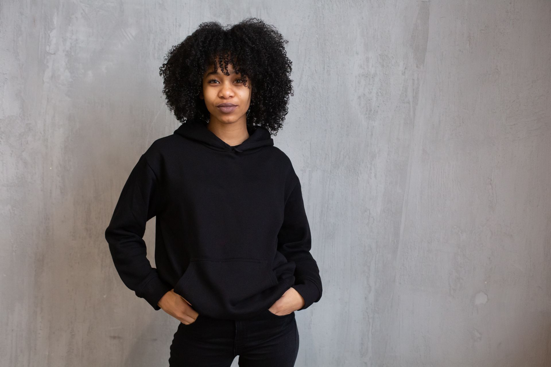 Woman wearing a plain black hoodie