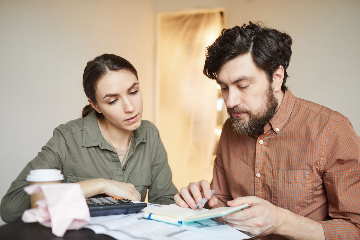 Financial advisor explaining documents to a couple at a table.