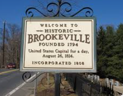A sign that says welcome to historic brookeville founded 1794 united states capital for a day. A sign that says welcome to historic brookeville founded 1794 united states capital for a day.