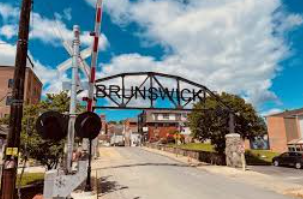 A train crossing with a sign that says brunswick on it. A train crossing with a sign that says brunswick on it.
