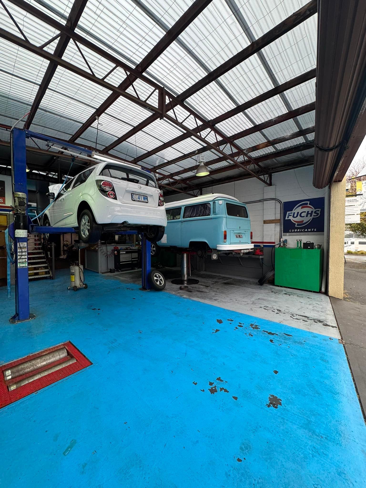 Two Cars on Lifts in an Auto Repair Garage — Van Diemen's Automotive & Electrical Repairs In Bellerive, TAS