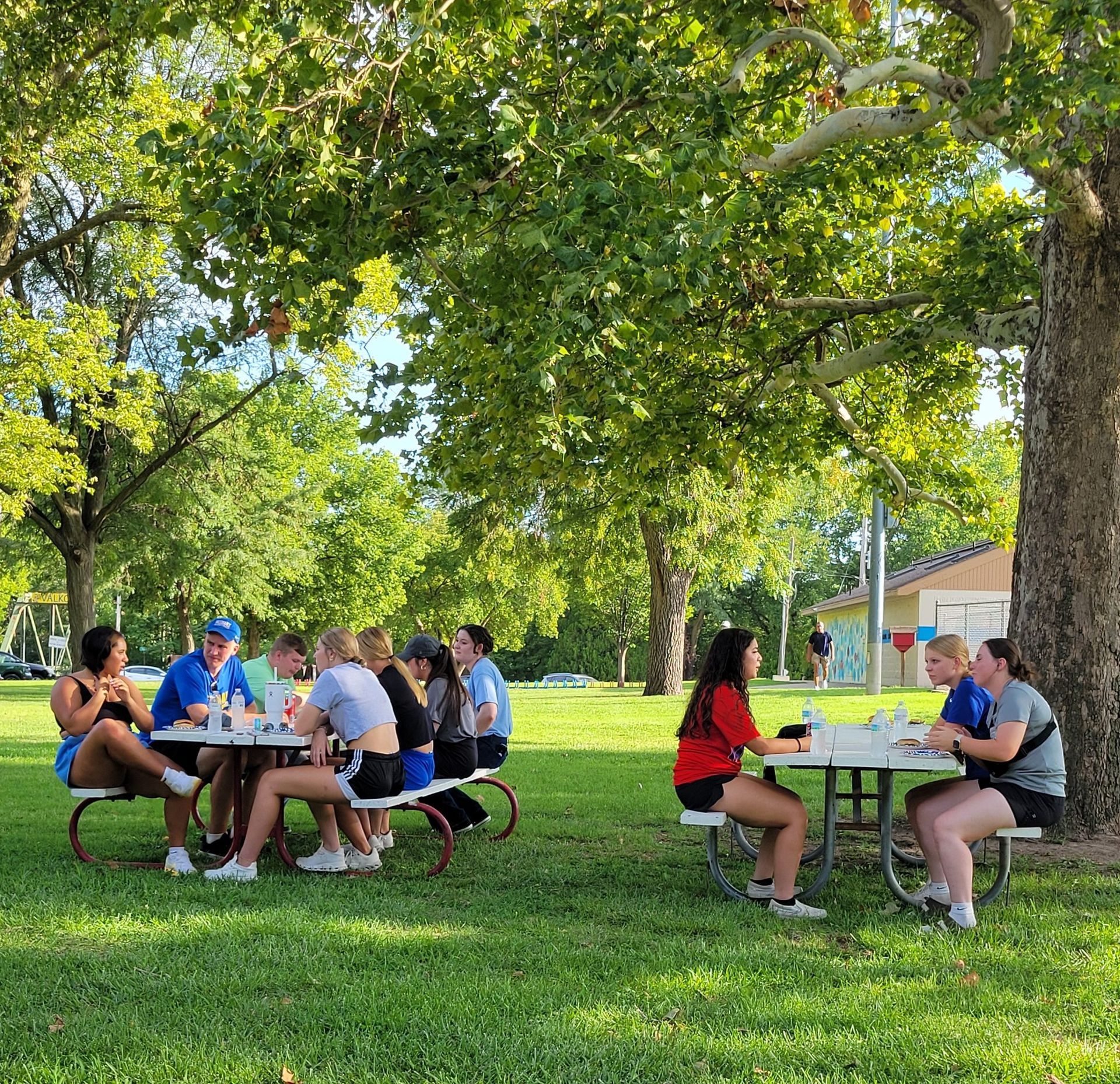 Students sitting at picnic tables
