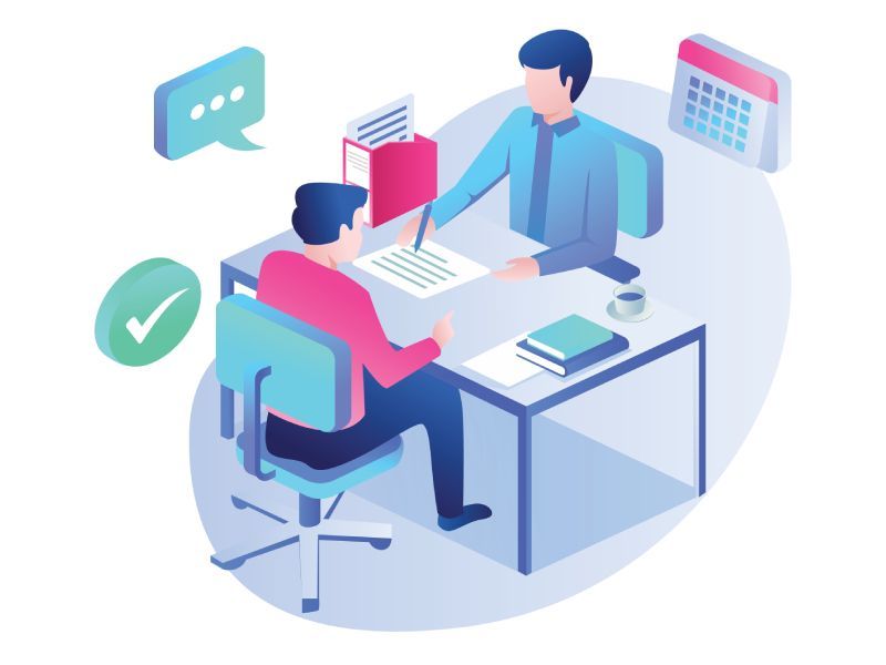 a man is sitting at a desk talking to another man