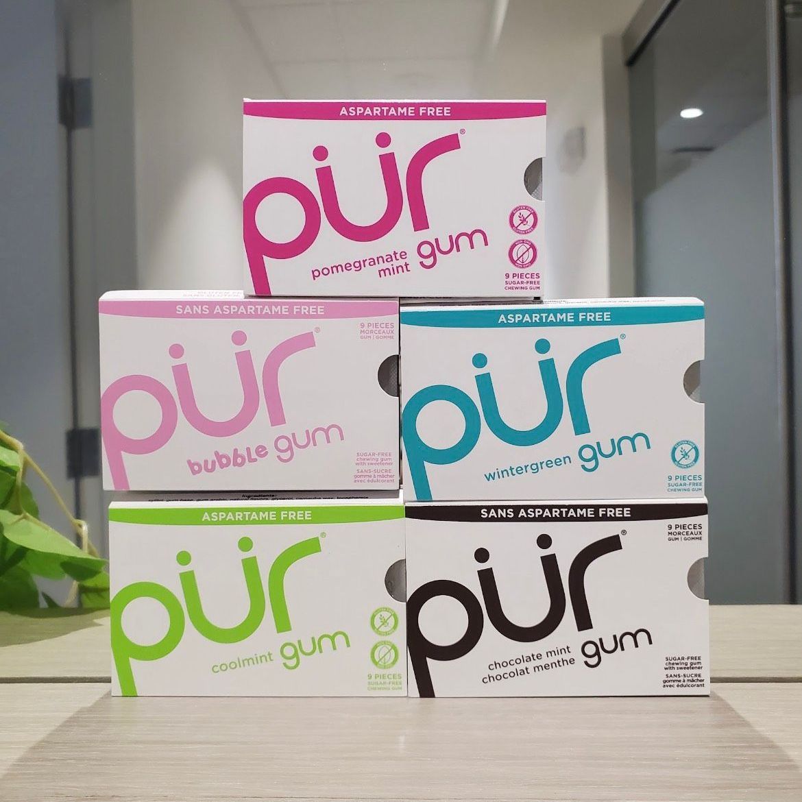 Five boxes of PUR gum stacked. Flavors include: peppermint, bubblegum, spearmint, pomegranate, and black currant.