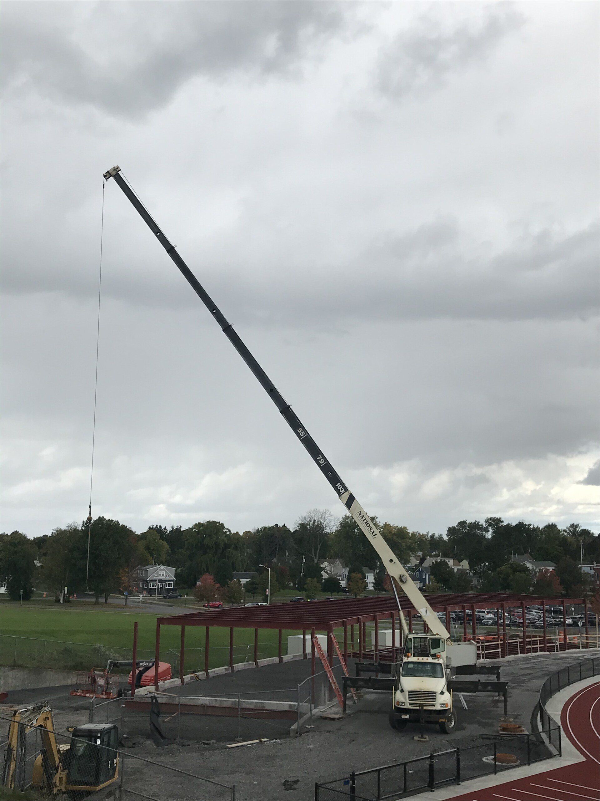 A large crane is being used to build a stadium