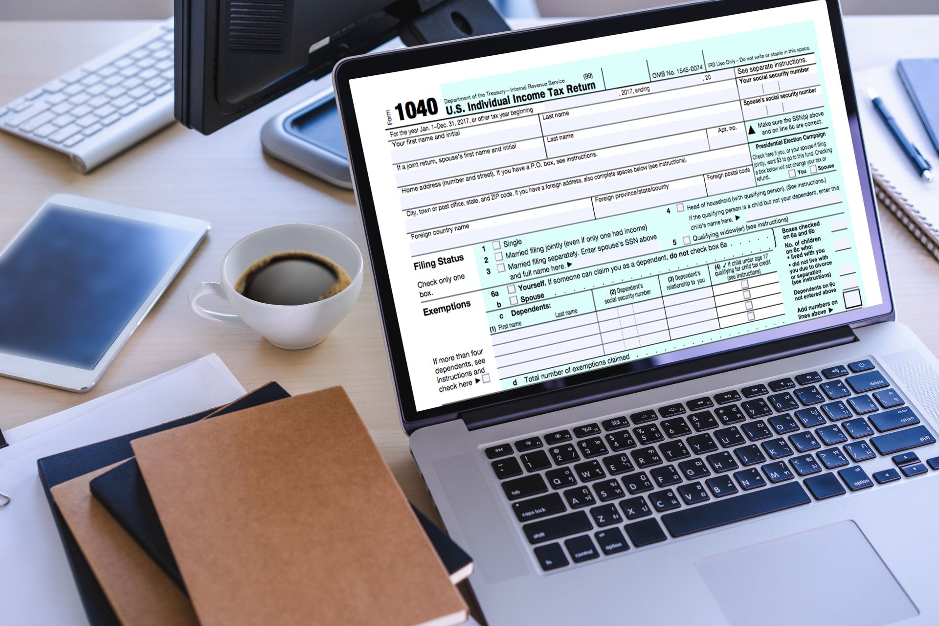 Laptop displaying a document on a desk with notebook, coffee cup, phone, and papers