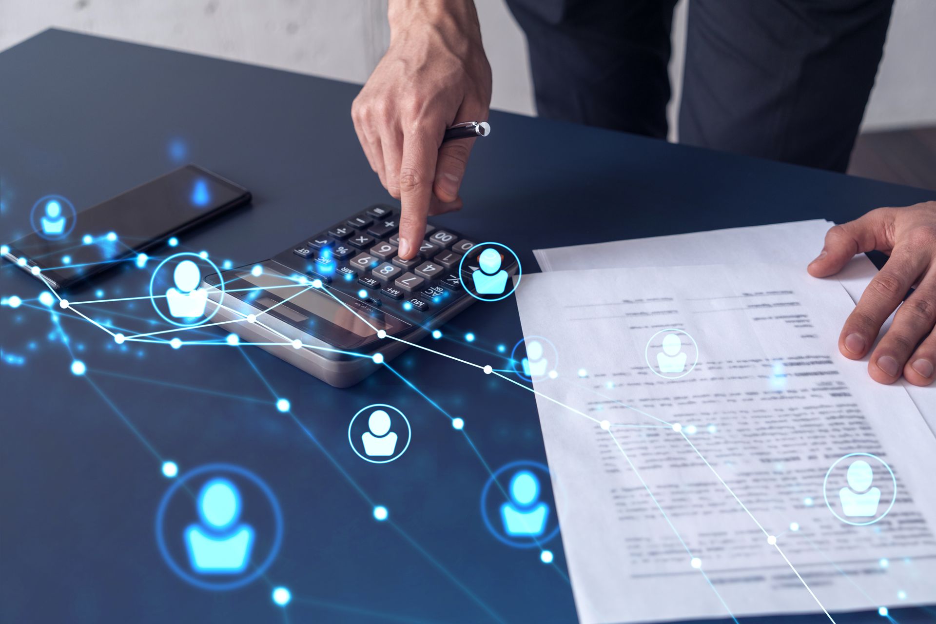 Hands typing on a laptop beside a document, with blue network icons overlaying the desk.