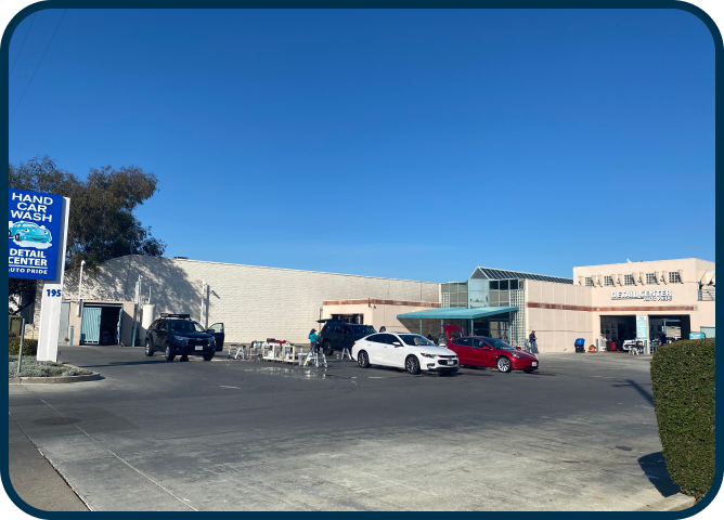 A car wash with cars parked in front of it