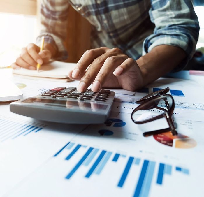 Businessman Working on Calculator — Madison, WI — EXACT Accounting & Financial Services