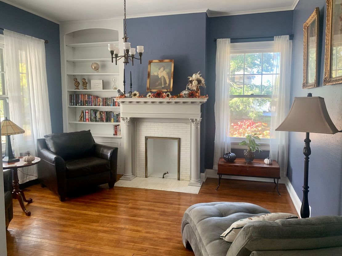 a living room with a fireplace and bookshelves