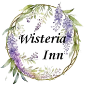 a logo for wisteria inn with purple flowers and green leaves