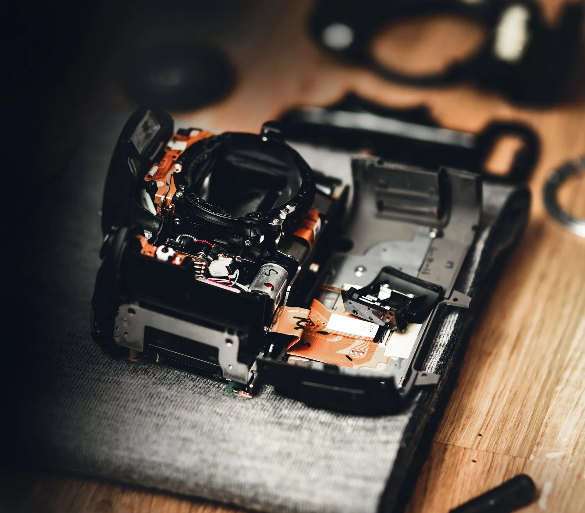 a black ricoh camera is sitting on a table .