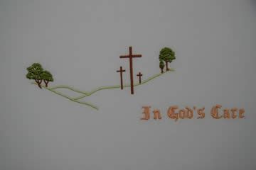 Three crosses on a hill with trees and the words