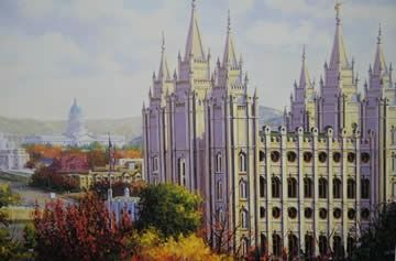Salt Lake Temple with spires and surrounding buildings, fall foliage.