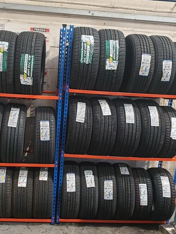 a bunch of tires are stacked on top of each other on a rack .
